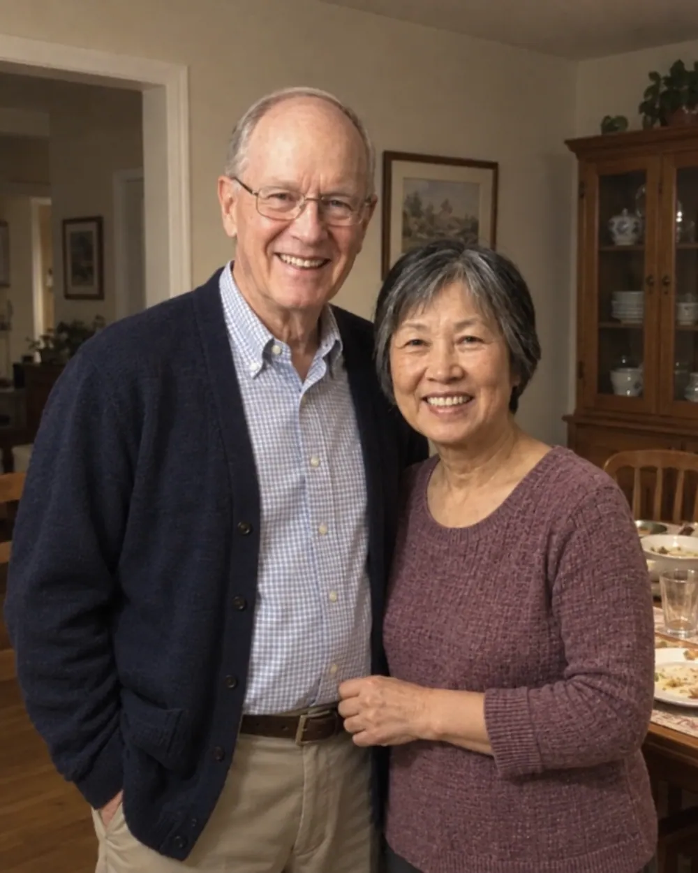 An older couple standing together at home after a family meal, photographed on a phone