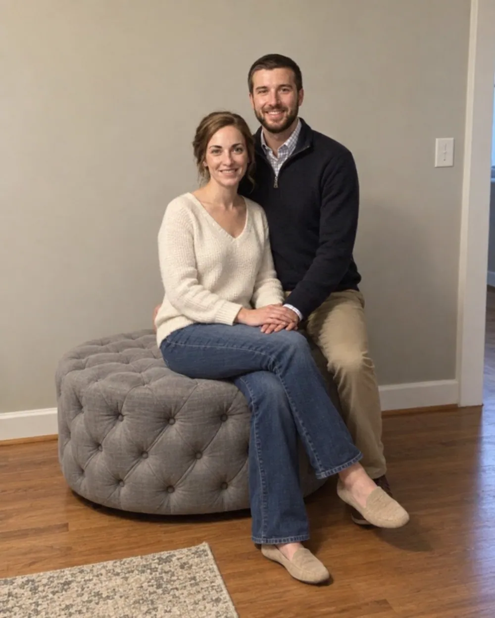 A bride and groom together at home in everyday clothes, photographed on a phone